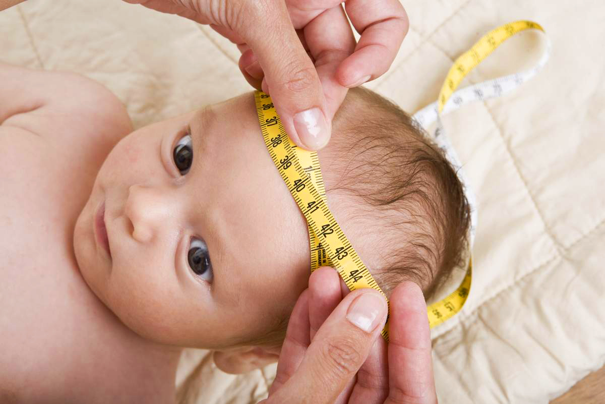 Infant getting his head measured