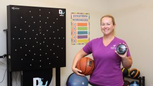 Certified Brain Injury Specialist - Laura Van Dusseldorp holding up equipment