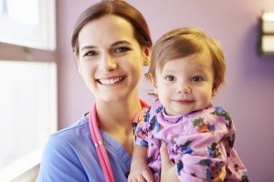 Pediatric Nurse holding a child.