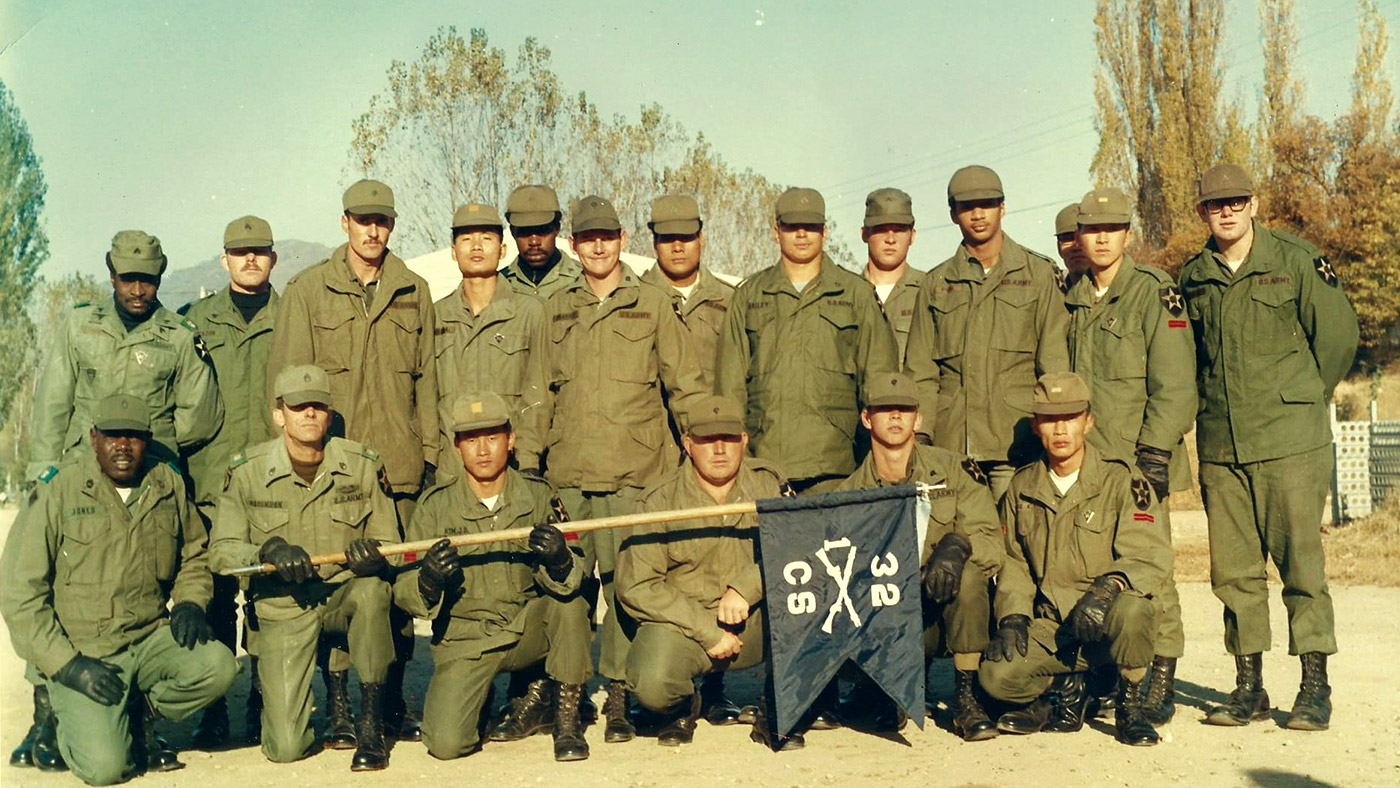 Steve Bailey, (standing behind the flag), is pictured here with his platoon in the 1970s.
